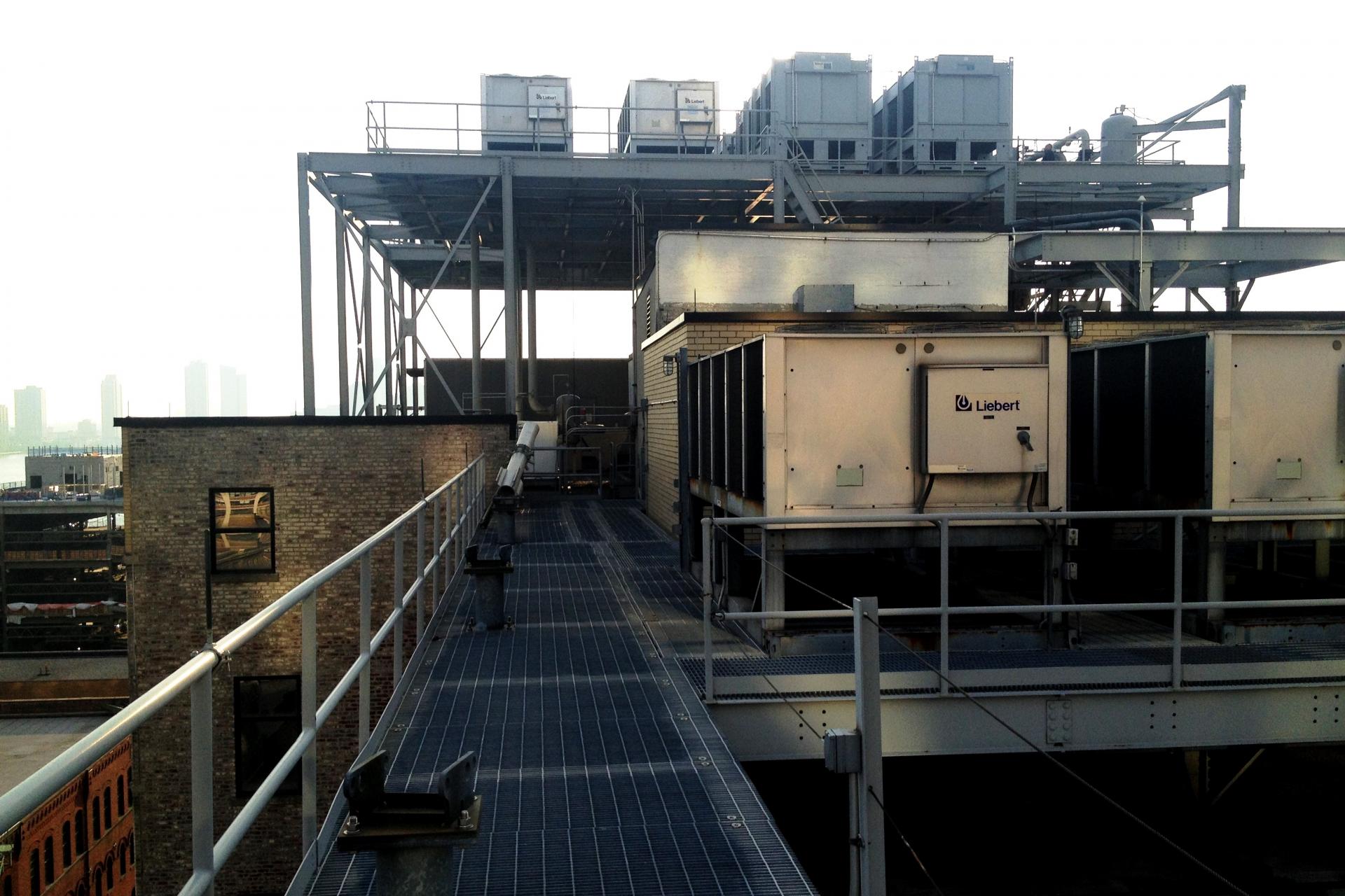 The concurrently maintainable cooling plant consists of dry coolers and air-cooled chillers located on roof dunnage and a dunnage penthouse. The generators are located rooftop as well. 